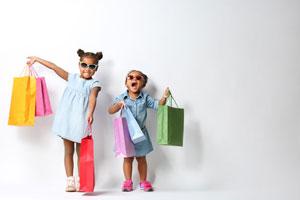 happy kids holding colorful shopping bags