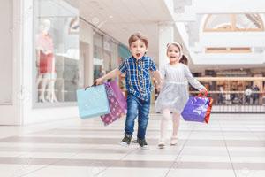 Adorable kids holding shopping bags